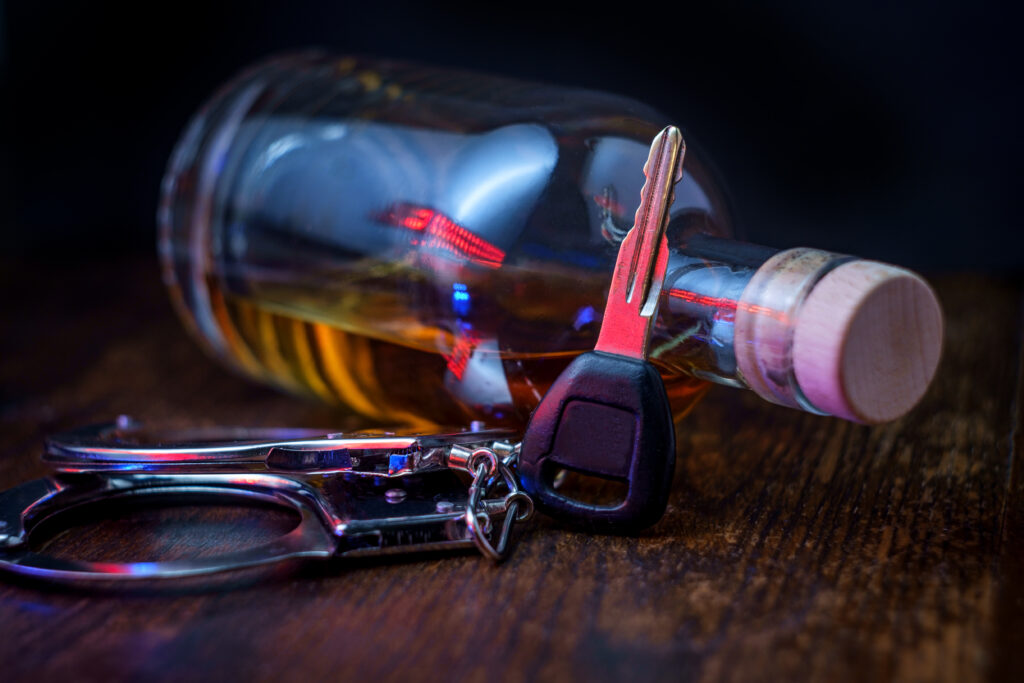 Half,Empty,Bottle,Of,Whisky,On,Rustic,Wooden,Bar,With car keys